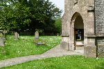 View toward the Curtis grave View past the church porch to a large Yew tree