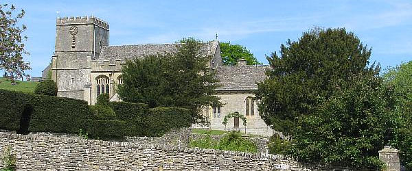 View to StAndrews Church View over a low stone wall to a limestone built church with a tower