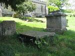 A slab monument and a chest tomb , to the right of the previous group