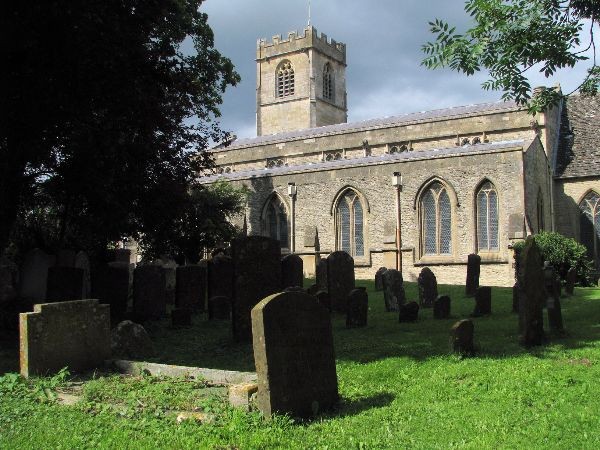 View across a graveyard to a large church with a tower